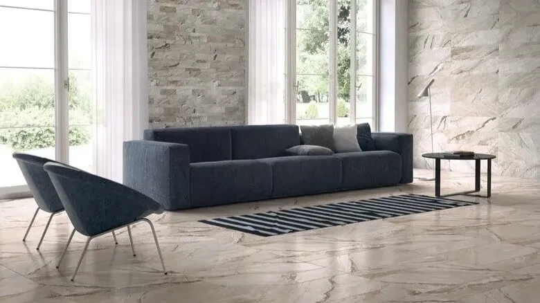 Modern living room with large format marble tile flooring and textured stone accent walls